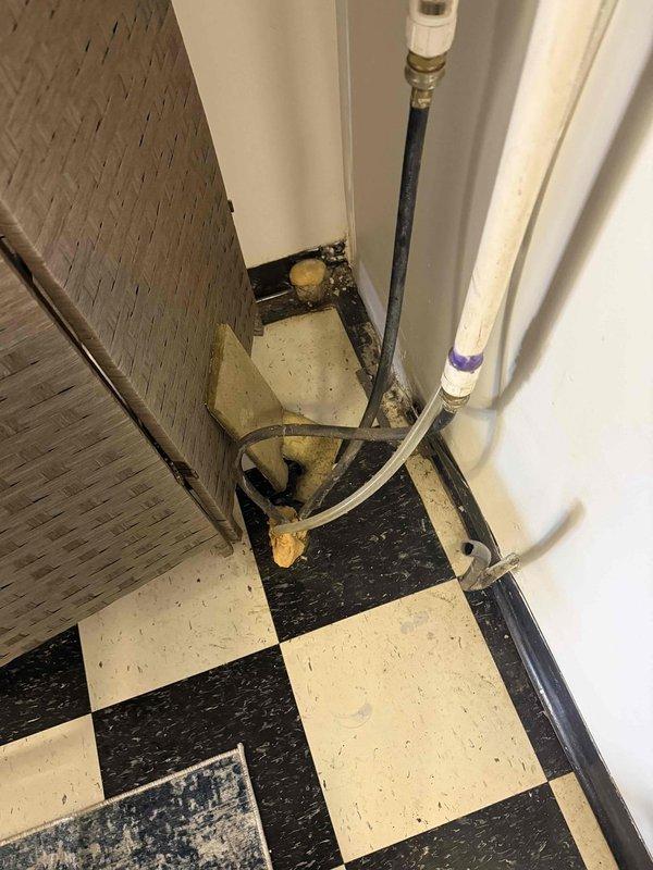 Responded to callback for recurring leak issue on commercial HVAC installation. Upon arrival, inspected PVC condensate drain line previously serviced and verified proper slope using torpedo level. Discovered accumulation of debris and mineral deposits at floor-level drain connection point indicating drainage system backup. Cleared blockage from drain line, cleaned connection fittings, and confirmed proper drainage flow to eliminate leak recurrence.