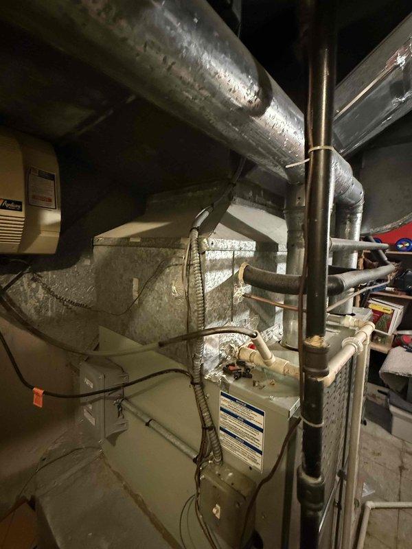 Responded to no cooling complaint on American Standard Allegiance 10 system (Model 7A0048A100A0, Serial K17294CCEF). Performed standard diagnostic evaluation of outdoor condensing unit and indoor air handler, verified thermostat settings, checked system breakers, and inspected air filter condition. Documented equipment information and captured photographic records of both indoor furnace/air handler installation and outdoor condensing unit for service file.