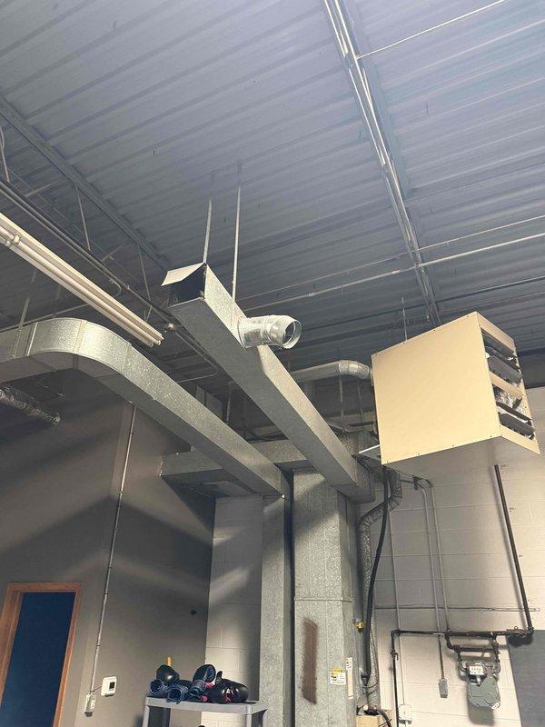 Responded to service call for non-operational air conditioning unit with reported burning rubber odor. Accessed mechanical room and conducted thorough inspection of HVAC system components, ductwork, and insulation. Documented existing conditions of equipment including insulated sections, ventilation connections, and mechanical unit mounting with photographic evidence for maintenance records.