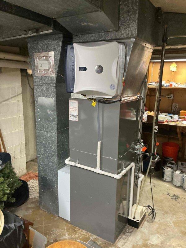 Completed comprehensive spring maintenance and clean-and-check service on a two-system HVAC installation consisting of a Carrier furnace and air conditioning system located in the basement mechanical room. Performed thorough inspection of both heating and cooling equipment, including evaluation of all electrical connections, refrigerant levels, condensate drainage systems, and air handler components per seasonal comfort plan protocol. All systems tested and verified operational with no deficiencies noted; equipment photographed for service records documenting proper installation configuration and current condition of furnace, air handler, ductwork connections, and associated PVC venting and drainage piping.