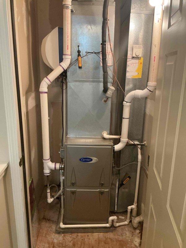 Completed comprehensive spring maintenance and clean-and-check service on a two-system HVAC installation consisting of a Carrier furnace and air conditioning system located in the basement mechanical room. Performed thorough inspection of both heating and cooling equipment, including evaluation of all electrical connections, refrigerant levels, condensate drainage systems, and air handler components per seasonal comfort plan protocol. All systems tested and verified operational with no deficiencies noted; equipment photographed for service records documenting proper installation configuration and current condition of furnace, air handler, ductwork connections, and associated PVC venting and drainage piping.