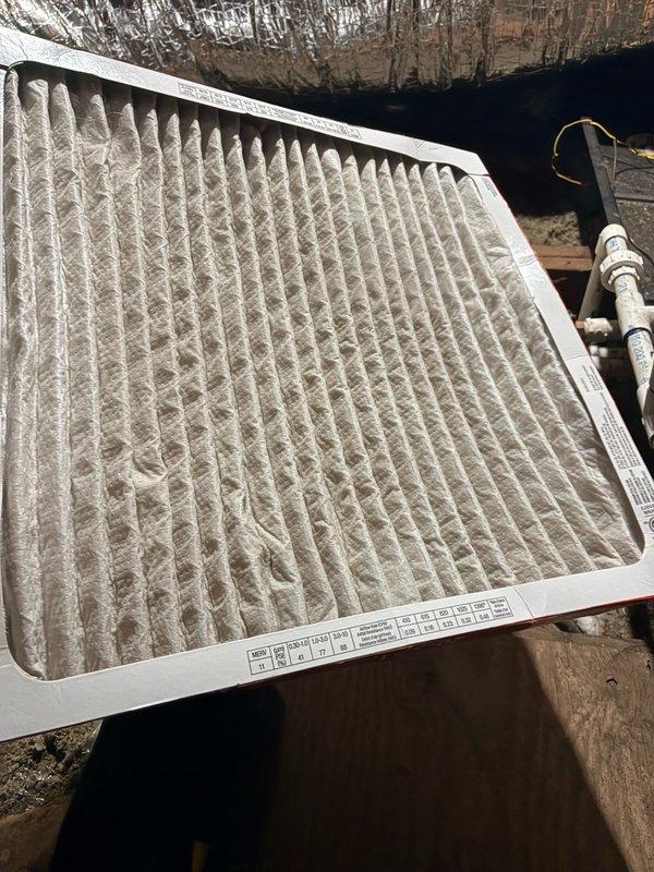 Responded to no-cooling call where air handler was operating but outdoor condensing unit failed to run. Upon arrival, performed system diagnostics on split HVAC system located in attic space. Inspected attic-mounted air handler and found heavily soiled air filter restricting airflow, which was replaced. Traced electrical supply to outdoor unit and identified failed contactor preventing compressor operation. Replaced defective contactor and verified proper voltage at compressor terminals. Tested system operation through complete cooling cycle, confirming outdoor unit engagement, proper refrigerant pressures, and adequate airflow at supply registers. Documented equipment information and photographed air handler installation and filter condition for service records. System restored to full cooling operation.