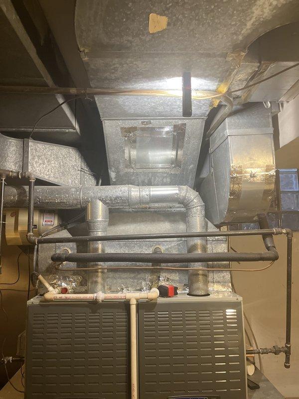 Responded to service call for non-cooling air conditioning system serviced by 4-ton unit with dual furnace configuration. Performed diagnostic evaluation of HVAC system including thermostat settings, air handler operation, and electrical components. Inspected existing equipment installation in mechanical room, documented current condition of ductwork, air handler unit, condensate drainage lines, and refrigerant piping. Provided comprehensive replacement estimate for complete system upgrade based on existing dual-zone configuration and equipment access limitations in utility space.