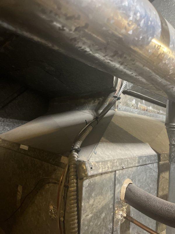 Responded to service call for non-cooling air conditioning system serviced by 4-ton unit with dual furnace configuration. Performed diagnostic evaluation of HVAC system including thermostat settings, air handler operation, and electrical components. Inspected existing equipment installation in mechanical room, documented current condition of ductwork, air handler unit, condensate drainage lines, and refrigerant piping. Provided comprehensive replacement estimate for complete system upgrade based on existing dual-zone configuration and equipment access limitations in utility space.