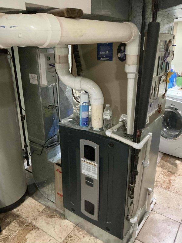 Completed follow-up maintenance call on 9-year-old residential air conditioning system following previous service visit. Performed system inspection and documentation of indoor air handler unit and outdoor condensing unit, verifying capacitor operation and electrical connections. All components photographed and system operational upon completion.