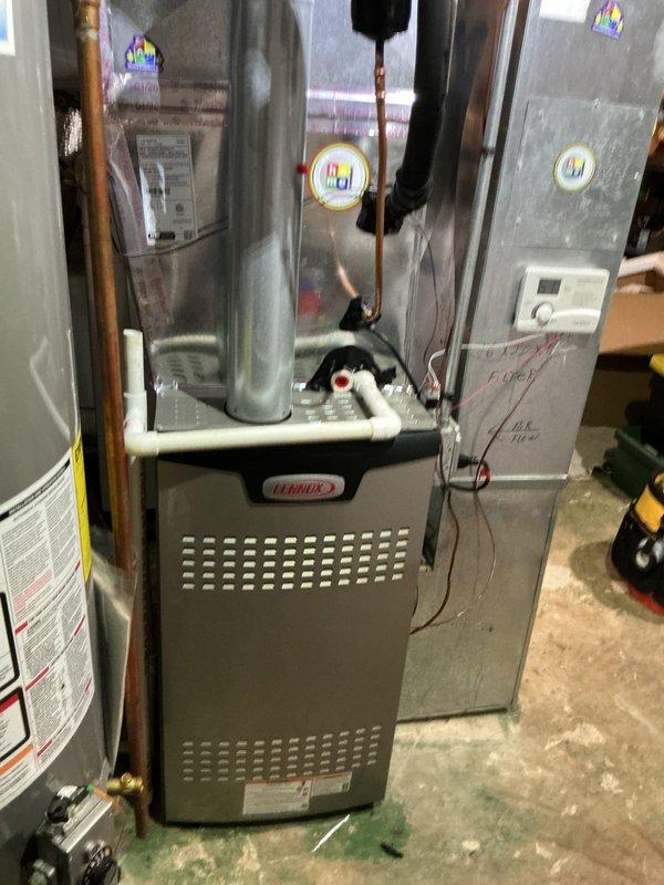 Completed full HVAC system replacement including furnace, air conditioning condenser, evaporator coil, and humidifier installation. Disconnected and properly disposed of existing forced air furnace and reclaimed refrigerant from old A/C system per EPA regulations. Installed new Lennox SL280UH090V36BK forced air furnace (Cat #26C64) and connected to existing supply and return ductwork with necessary sheet metal transitions. Attached furnace to existing gas line, electrical circuit, and exhaust system. Installed new Lennox air conditioning condensing unit on new pad with pea gravel and mounted new evaporator coil above furnace. Connected A/C system to existing copper refrigerant lines, evacuated system to remove moisture and air, and charged with R454B refrigerant to manufacturer specifications. Installed Aprilaire humidifier and integrated with new system. Performed complete start-up procedures, tested all equipment for proper operation, adjusted airflow and refrigerant charge as needed