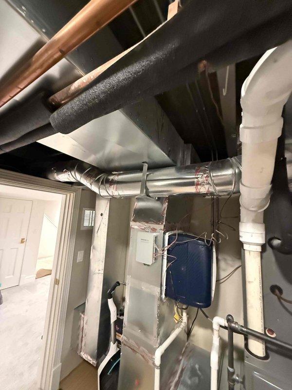 Responded to customer complaint of excessive indoor humidity despite air conditioning operation. Upon inspection, discovered heavy frost accumulation on refrigerant suction line in mechanical room, indicating restricted airflow or low refrigerant charge. Documented frozen evaporator coil condition with photographic evidence. Inspected outdoor condenser unit and verified operational status. Diagnosed system airflow restriction causing coil icing and subsequent humidity control issues. Collected equipment information for service records and discussed preventative maintenance options with customer.