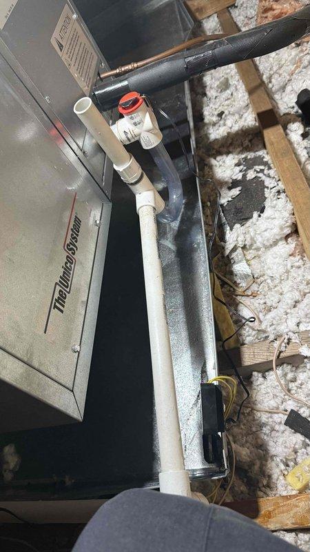 Responded to no cooling call on WeatherMaker air handler system less than five years old located in attic space. Performed diagnostic inspection of unit and associated components including condensate drainage system, ductwork connections, and electrical wiring. Documented equipment condition and attic installation with reflective duct insulation, spray foam insulation, and PVC condensate lines with proper trap configuration.