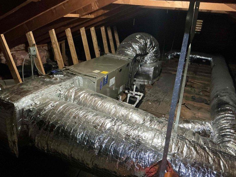 Responded to return visit for AC system with persistent refrigerant leak and complete power failure following previous repair attempt. Upon arrival, conducted comprehensive diagnostic evaluation of attic-mounted air handler and associated components. Inspection revealed significant corrosion on copper refrigerant lines and deteriorated condition of multiple system components, including compromised evaporator coil connections. System exhibited evidence of ongoing leak with moisture accumulation in drain pan area. Verified electrical connections, breaker status, and thermostat settings—unit failed to power on during initial testing. Traced power issue to damaged wiring or control board failure related to previous service work. Documented extensive rust and oxidation on refrigerant tubing, indicating prolonged exposure to moisture and potential multiple leak points. Photographed corroded copper lines, deteriorated mounting hardware, and overall system condition in attic installation. Give