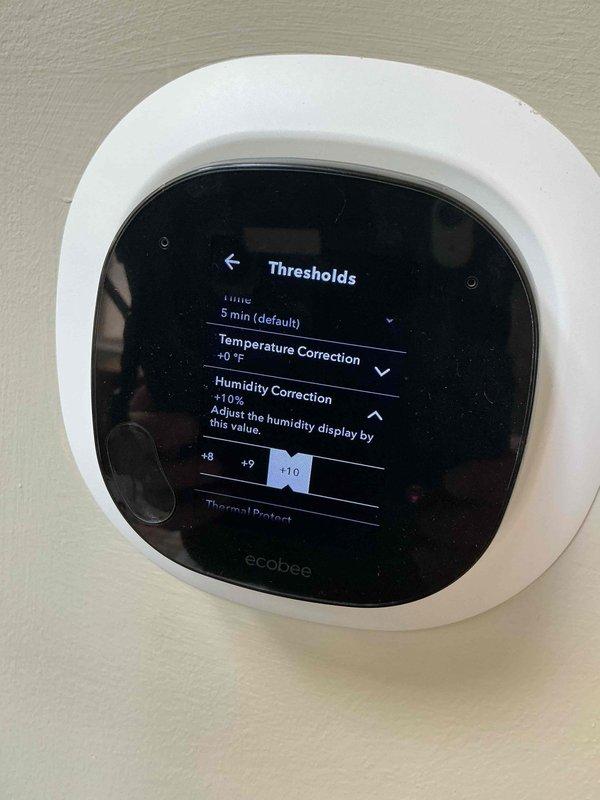 Responded to no cooling complaint with excessive humidity concerns. Upon inspection, found ecobee smart thermostat humidity settings incorrectly configured with +10% humidity correction offset, causing inaccurate humidity readings and improper system operation. Adjusted thermostat humidity correction from +10% to proper calibration and configured "Dehumidify Using AC" function to 64% setpoint to optimize comfort and system performance. Verified thermostat settings, cooling mode operation, and system functionality. Unit now operating properly with correct humidity control parameters programmed.