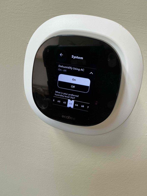 Responded to no cooling complaint with excessive humidity concerns. Upon inspection, found ecobee smart thermostat humidity settings incorrectly configured with +10% humidity correction offset, causing inaccurate humidity readings and improper system operation. Adjusted thermostat humidity correction from +10% to proper calibration and configured "Dehumidify Using AC" function to 64% setpoint to optimize comfort and system performance. Verified thermostat settings, cooling mode operation, and system functionality. Unit now operating properly with correct humidity control parameters programmed.
