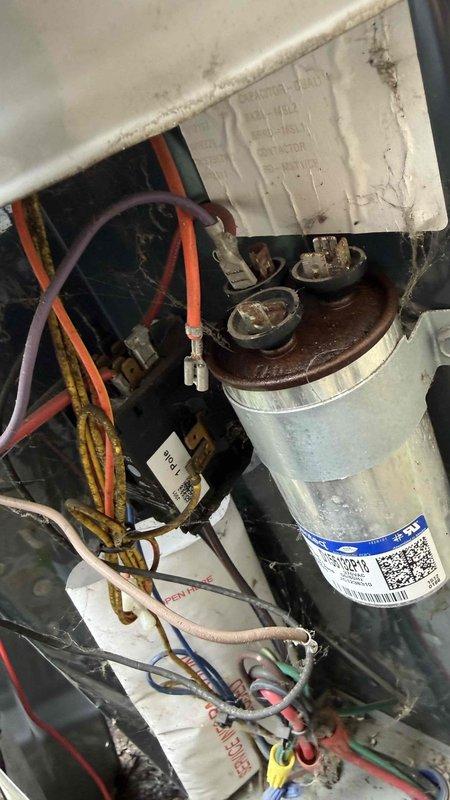 Responded to no cooling complaint on residential air conditioning system. Upon inspection, diagnosed failed dual run capacitor with visible corrosion on terminal cap and tested electrical readings confirming capacitor failure. Replaced defective capacitor, verified proper voltage and amperage readings at compressor and blower motor, and confirmed system returned to normal cooling operation.