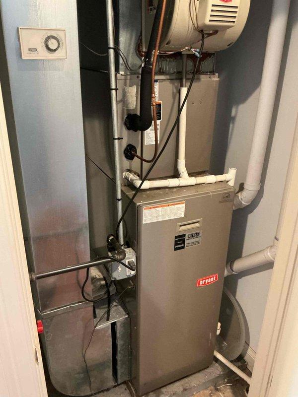 Responded to no cooling complaint on Bryant residential HVAC system less than five years old. Upon inspection, found outdoor condenser unit with heavily restricted airflow due to significant dust and debris accumulation on coil fins and grille openings. Documented equipment condition with photos showing utility closet installation and exterior unit with visible contamination blocking proper heat exchange. Diagnosed airflow restriction as primary cause of cooling failure and discussed cleaning requirements and maintenance recommendations with property owner to restore system performance.