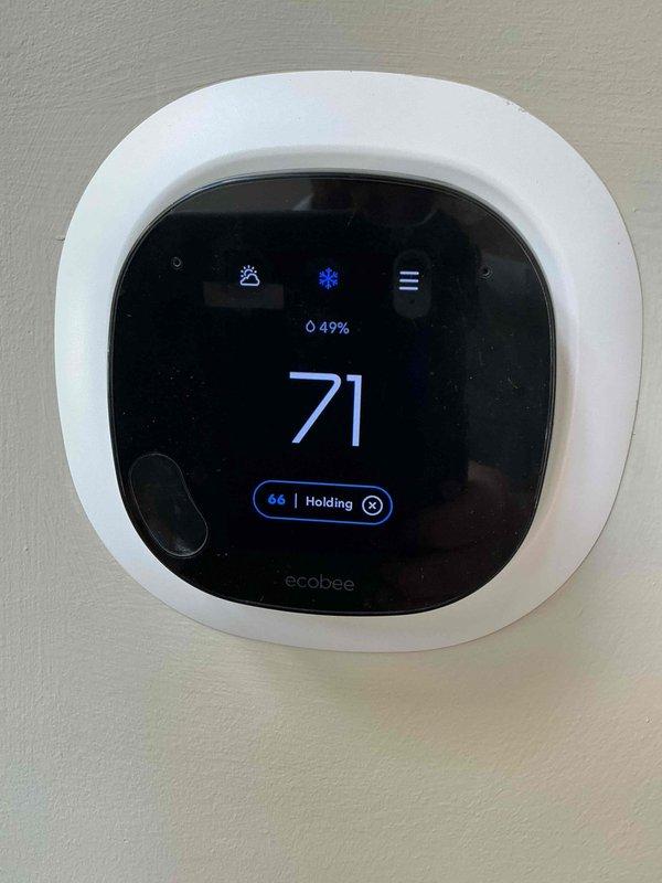 Responded to no cooling complaint at commercial tenant space. Upon arrival, verified ecobee thermostat was displaying and holding at setpoint but system was not providing adequate cooling. Tenant reported ongoing issues with thermostat resetting itself intermittently. Previous service visit suspected electrical issues, and electrical contractor had verified power supply was functioning properly. 

Inspected thermostat operation and confirmed unit was calling for cooling mode as indicated by snowflake icon on display. Thermostat showed current temperature of 73°F with setpoint of 69°F and holding schedule until 6:30pm. Humidity reading displayed at 57%. Checked thermostat wiring connections at wall plate and verified secure terminations. Monitored thermostat communication with HVAC equipment to determine if cooling call was being properly transmitted to air handler and condensing unit. Further diagnostic work required at equipment level to determine root cause of no cooling condition an