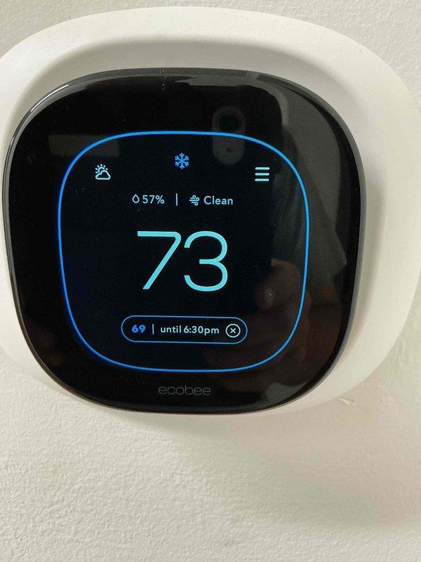 Responded to no cooling complaint at commercial tenant space. Upon arrival, verified ecobee thermostat was displaying and holding at setpoint but system was not providing adequate cooling. Tenant reported ongoing issues with thermostat resetting itself intermittently. Previous service visit suspected electrical issues, and electrical contractor had verified power supply was functioning properly. 

Inspected thermostat operation and confirmed unit was calling for cooling mode as indicated by snowflake icon on display. Thermostat showed current temperature of 73°F with setpoint of 69°F and holding schedule until 6:30pm. Humidity reading displayed at 57%. Checked thermostat wiring connections at wall plate and verified secure terminations. Monitored thermostat communication with HVAC equipment to determine if cooling call was being properly transmitted to air handler and condensing unit. Further diagnostic work required at equipment level to determine root cause of no cooling condition an