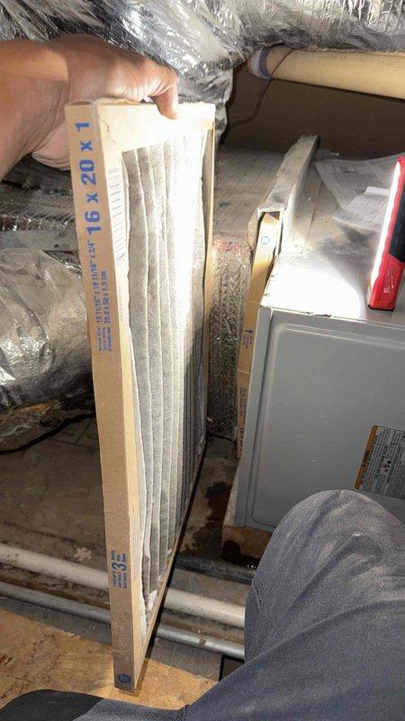 Responded to water leak complaint on recently installed air conditioning system. Upon inspection, found severely restricted airflow due to heavily soiled air filter causing condensate overflow from drain pan. Documented existing ductwork configuration and HVAC unit installation in attic space, confirmed proper drain line installation with no leaks present. Issue determined to be maintenance-related rather than installation defect, as clogged filter restricted airflow causing excessive condensation and backup.