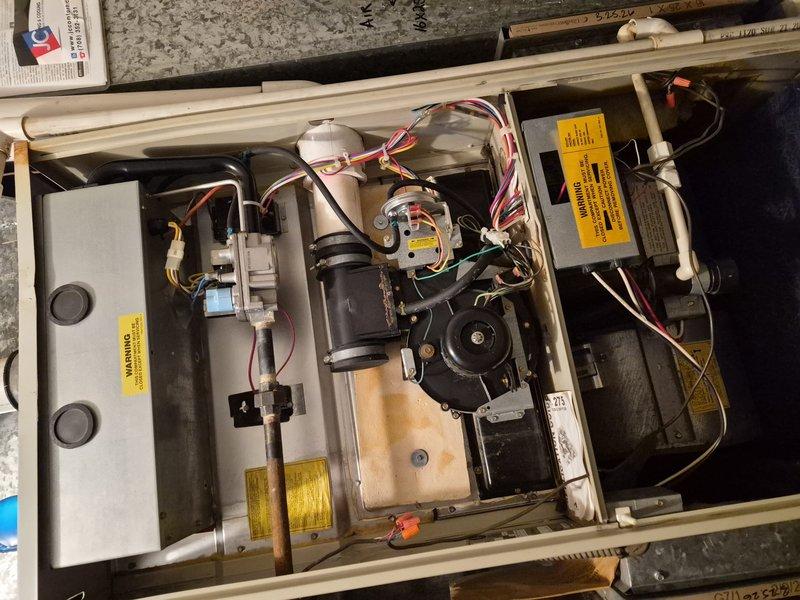Responded to no cooling complaint at commercial office space. Upon inspection, found HVAC unit with accessible compartment showing gas valve assembly, ignition control module, and blower motor connections intact. Verified all electrical connections secure, checked capacitor and contactor operation within normal parameters. System components inspected and photographed for documentation purposes. Unit operational at time of departure with cooling restored to occupied space.