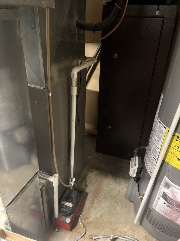 Conducted site evaluation for complete HVAC system replacement estimate on approximately 15-year-old equipment. Customer reported furnace producing whining noise and air conditioning condenser with unbalanced fan operation. Assessed outdoor condensing unit positioned on concrete pad against exterior brick wall and inspected indoor air handler/furnace system located in basement mechanical room, documenting existing equipment specifications and installation configuration for replacement proposal.