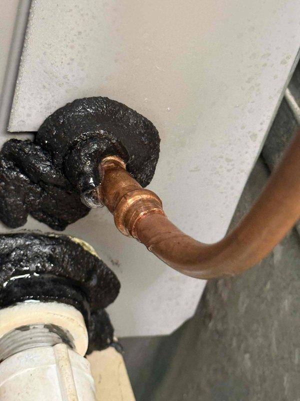 Responded to no cooling complaint at commercial office space where indoor temperature had risen to 84 degrees. Upon arrival, coordinated building access and conducted system evaluation. Inspected refrigerant lines and connections, documenting copper piping with visible patina and insulated refrigerant lines showing condensation. Followed required approval process by contacting office to coordinate authorization through property management for diagnostic and repair work.