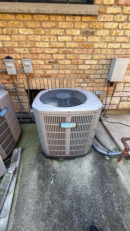Responded to no cooling complaint on residential split system air conditioning unit approximately 7-8 years old. Upon arrival, performed initial diagnostic assessment of outdoor condenser unit and indoor air handler system. Verified thermostat settings, checked air filter condition, and confirmed electrical breaker status. Conducted visual inspection of condenser unit mounted on exterior concrete pad, examining refrigerant lines, electrical disconnect, and overall equipment condition. Inspected indoor furnace and air handler components located in utility closet, including associated ductwork and PVC condensate piping. Documented equipment information and captured photos of both outdoor and indoor HVAC components for service records.