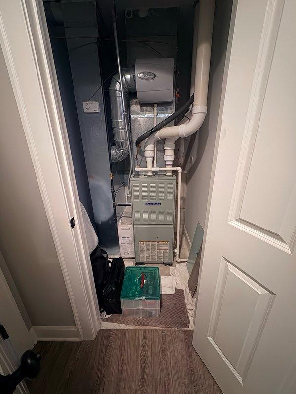 Responded to no cooling complaint on residential split system air conditioning unit approximately 7-8 years old. Upon arrival, performed initial diagnostic assessment of outdoor condenser unit and indoor air handler system. Verified thermostat settings, checked air filter condition, and confirmed electrical breaker status. Conducted visual inspection of condenser unit mounted on exterior concrete pad, examining refrigerant lines, electrical disconnect, and overall equipment condition. Inspected indoor furnace and air handler components located in utility closet, including associated ductwork and PVC condensate piping. Documented equipment information and captured photos of both outdoor and indoor HVAC components for service records.