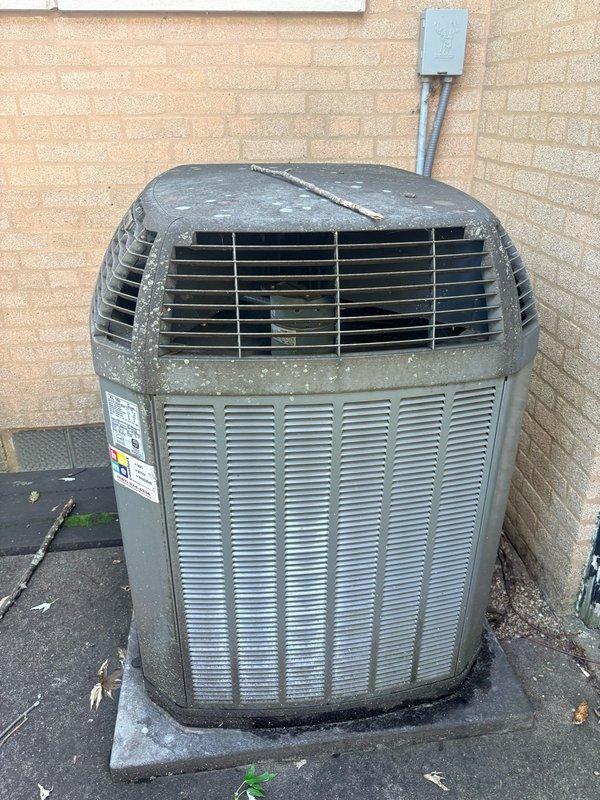 Completed spring preventive maintenance clean and check on single AC system per comfort plan agreement. Performed comprehensive inspection of outdoor condenser unit, cleaned accumulated debris from top grille and surrounding surfaces, and verified electrical connections with multimeter showing 513V reading. Replaced 16x25x4 air filter and confirmed system operating within normal parameters.