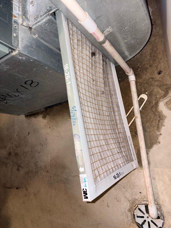 Responded to service call for air conditioning system struggling to maintain cooling. Upon inspection, found evaporator coil heavily frosted with significant ice buildup on refrigeration fins, indicating restricted airflow or low refrigerant charge. Discovered air filter extremely dirty and clogged with dust accumulation, restricting return air to the system. Replaced dirty air filter with new filter and allowed coil to defrost. Identified restricted airflow from dirty filter as primary cause of freezing condition. System airflow restored to proper operation after filter replacement and coil defrosting.