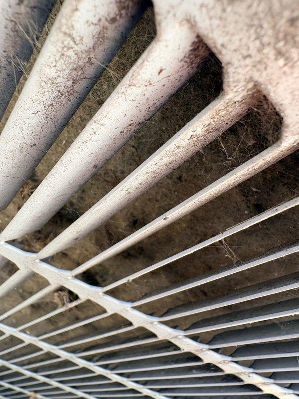 Responded to service call for air conditioning system struggling to maintain cooling. Upon inspection, found evaporator coil heavily frosted with significant ice buildup on refrigeration fins, indicating restricted airflow or low refrigerant charge. Discovered air filter extremely dirty and clogged with dust accumulation, restricting return air to the system. Replaced dirty air filter with new filter and allowed coil to defrost. Identified restricted airflow from dirty filter as primary cause of freezing condition. System airflow restored to proper operation after filter replacement and coil defrosting.