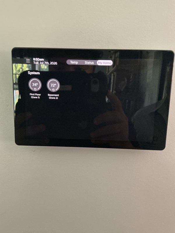Installed new thermostat wire to basement zone and connected to zone control panel. The multi-zone HVAC system now has proper communication between the smart thermostat display and the basement Zone 2, allowing independent temperature control of the first floor (Zone 1) and basement (Zone 2) areas.