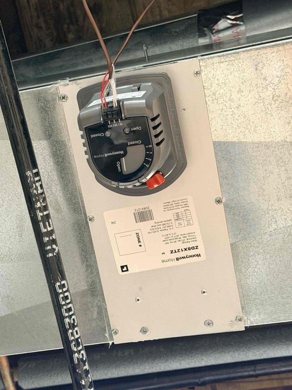 Replaced defective Honeywell zone damper control module (model ZDBX1Z1Z) in the HVAC zoning system. Removed the failed damper actuator from the sheet metal ductwork, installed new replacement unit, reconnected all control wiring and power supply, and verified proper operation of the zone control system with all indicator lights functioning correctly.