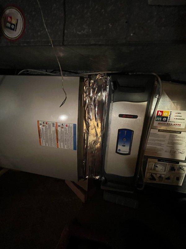 Completed callback for HVAC installation follow-up to address air leakage issues around media cabinet ductwork. Sealed openings at bottom and backside of media cabinet where ductwork connections were allowing conditioned air loss. Inspected air handler unit in basement utility space and verified proper operation of equipment. Documented all work with photos showing unit installation and surrounding conditions for service records.
