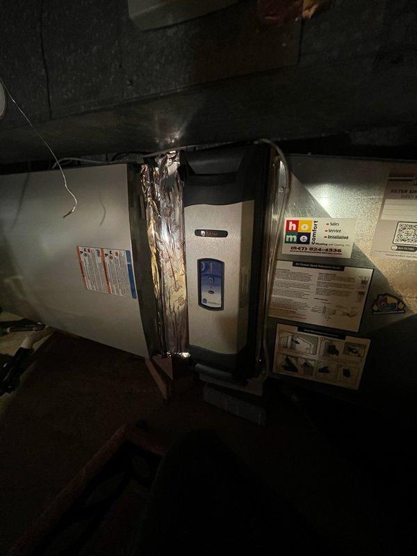 Completed callback for HVAC installation follow-up to address air leakage issues around media cabinet ductwork. Sealed openings at bottom and backside of media cabinet where ductwork connections were allowing conditioned air loss. Inspected air handler unit in basement utility space and verified proper operation of equipment. Documented all work with photos showing unit installation and surrounding conditions for service records.
