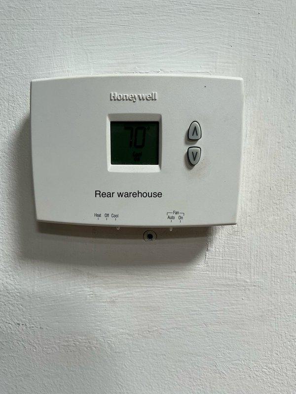 Responded to no cooling complaint at commercial facility. Inspected two Honeywell thermostats serving front office and rear warehouse areas. Both units displayed proper temperature readings and appeared to be in operational condition at time of service. Customer service appointment completed with system status documented via photos.