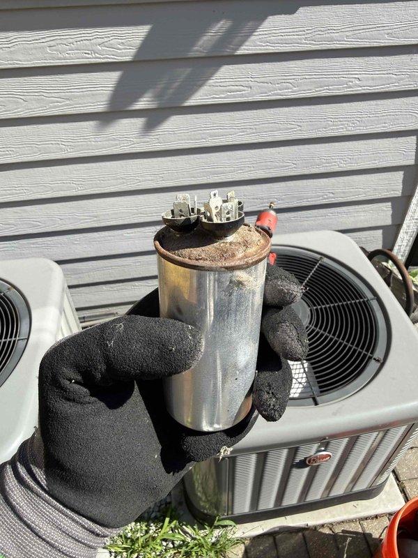 Responded to no cooling complaint and performed diagnostic evaluation of air conditioning system. Found failed capacitor with visible corrosion and deterioration affecting compressor operation. Replaced defective capacitor with new component, verified proper electrical connections, and tested system operation. Unit restored to normal cooling function with temperature readings confirming adequate performance.