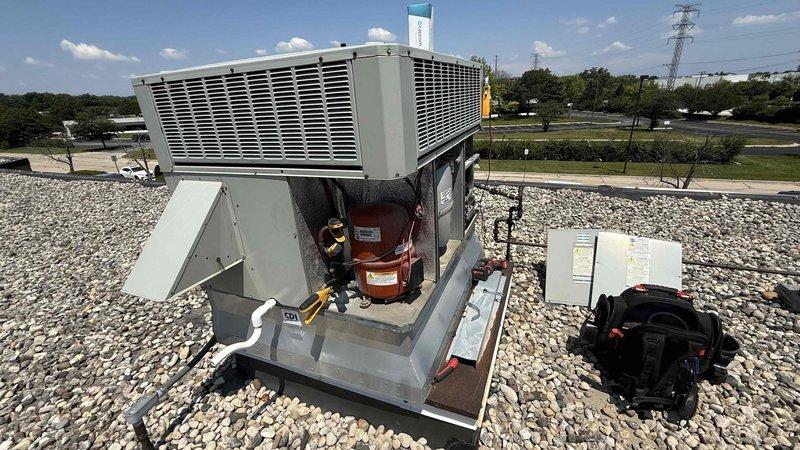 Responded to commercial rooftop HVAC unit requiring capacitor replacement. Replaced defective hard start capacitor and dual-run 35/5 capacitor on packaged rooftop unit. Accessed internal compressor compartment, removed failed capacitors, installed new components with proper electrical connections, and verified all wire terminations were secure. Unit tested and returned to normal operation.