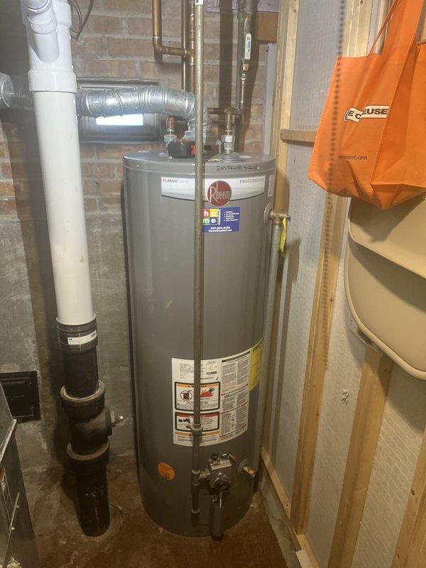 Conducted water heater replacement estimate for a 10-year-old Rheem unit with previous rust issues. Assessed existing power vent configuration with PVC venting system and documented current installation measurements and specifications. Customer requested proactive replacement evaluation due to prior deterioration concerns.