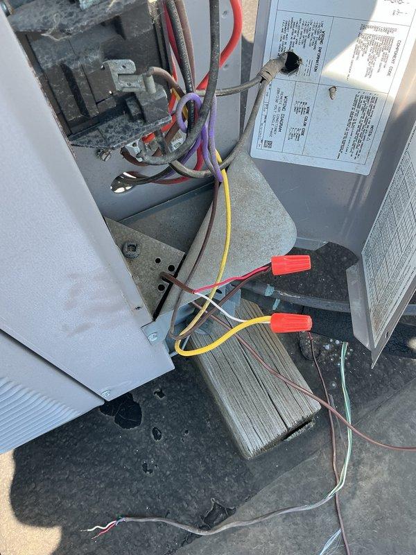 Completed commercial HVAC maintenance visit where new control wiring was installed from the rooftop air conditioning unit to the furnace system. Electrical connections were tested and verified operational, with junction box wiring secured and properly terminated.