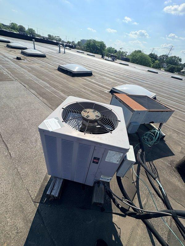 Completed commercial HVAC maintenance visit where new control wiring was installed from the rooftop air conditioning unit to the furnace system. Electrical connections were tested and verified operational, with junction box wiring secured and properly terminated.