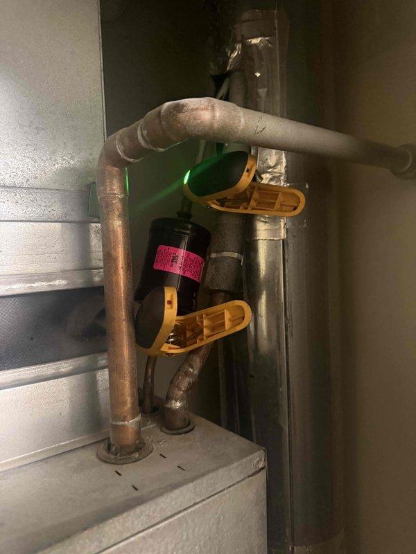 Responded to no cooling complaint on aging air conditioning system experiencing repeated evaporator coil freezing at the filter location. Upon arrival, performed diagnostic evaluation and measured system temperatures, recording 176°F at key component. Inspected refrigerant lines, evaporator coil assembly, and associated mechanical components for airflow restrictions, refrigerant charge issues, and potential system failures. Documented equipment condition with photos showing copper refrigerant piping, coil assembly, and mechanical connections. Customer had previously replaced filter and allowed unit to defrost before restart, but freezing recurred, indicating underlying airflow deficiency or low refrigerant charge requiring further evaluation and repair recommendations.