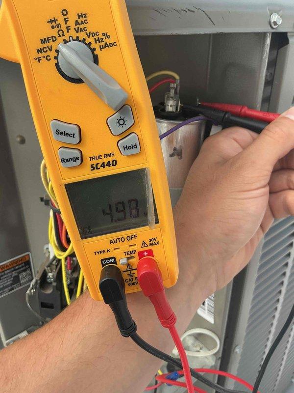 Completed comprehensive tune-up and preventive maintenance on rooftop HVAC system. Performed electrical diagnostics using digital multimeter, verified voltage readings at control panel showing 490V, and inspected all wiring connections including power and control circuits. All equipment operating within normal parameters, system clean and clear with no corrections needed at this time.
