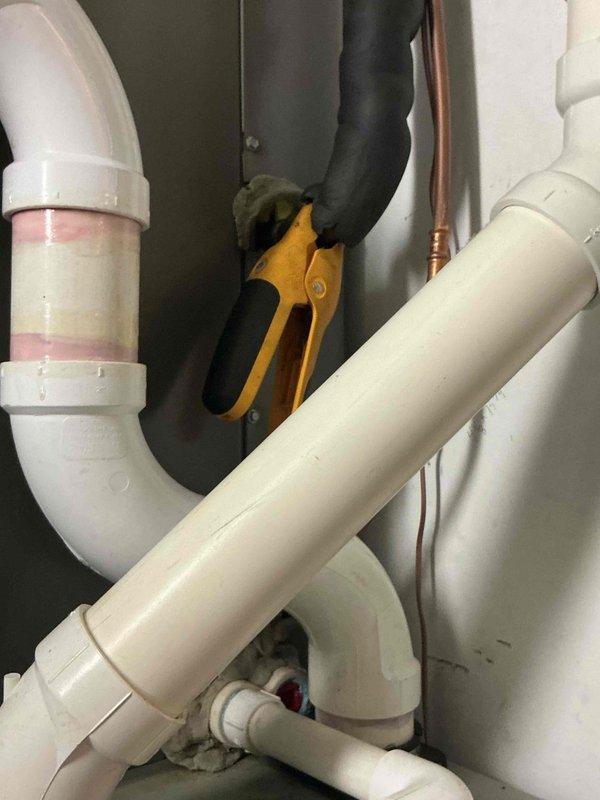 Responded to callback for cooling system with water leakage issue on 6-9 year old equipment. Addressed clogged condensate drain line causing overflow in drain pan and saturated air filter. Cleared blockage in condensate drainage system, verified proper flow, and inspected associated plumbing connections and drain pan assembly to ensure system was draining correctly.