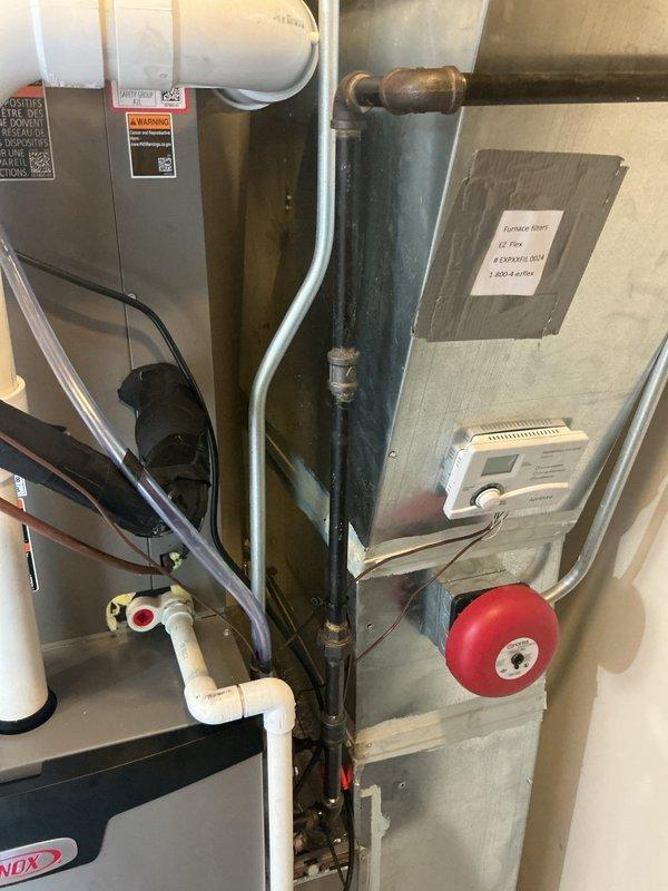 Completed final connections on new HVAC system installation, including flue pipe connections, gas line hookup, and initial furnace startup. All PVC venting, copper refrigerant lines, condensate drainage, and electrical connections were verified for proper operation, with system successfully fired up and confirmed operational.