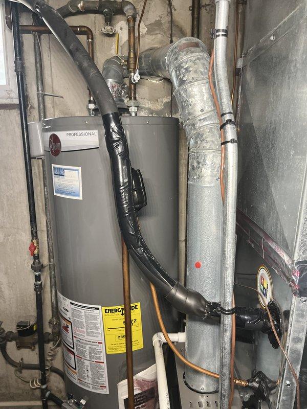 Completed quality follow-up inspection on residential HVAC system and water heater installation. Documented system configuration including furnace/air handler unit with supply ductwork, water heater with proper piping connections, and all associated refrigerant lines and utility connections. Verified all components are properly installed with adequate insulation on ductwork and refrigerant lines. System operational and performing as expected.