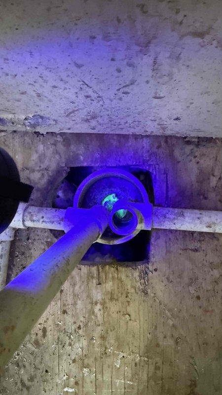 Responded to callback for AC unit not cooling after previous day's service where refrigerant and sealant were added. Upon inspection, discovered significant refrigerant leak at evaporator coil. Used UV light and fluorescent dye to confirm active leak at corroded copper U-bend connections. Found heavy corrosion on refrigerant lines with frost accumulation indicating ongoing refrigerant loss. Documented findings with photos showing compromised coil assembly requiring replacement under warranty.