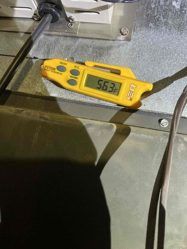 Completed complimentary preventive maintenance clean and check on HVAC system per comfort plan agreement. During inspection, identified biological growth (mold/algae) on evaporator coil assembly and vertical support bracket requiring attention. Documented system temperature readings at 56.3°F, photographed equipment condition including fin assembly with visible contamination and debris accumulation on coil surfaces. Noted unit showing signs of moisture retention contributing to microbial growth, with dust and dirt buildup present throughout fin sections. System assessed and documented for follow-up cleaning recommendations to restore optimal performance and indoor air quality.