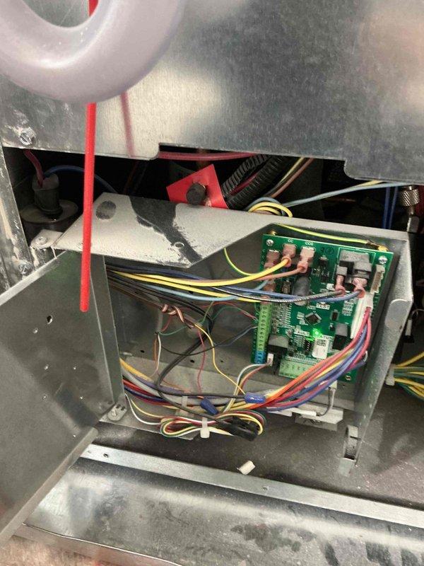Responded to no cooling call on recently installed system under warranty. Upon arrival, inspected control board and wiring connections within furnace cabinet. Found loose wire connection at control board terminal block that had worked free since installation. Secured all wire connections to circuit board terminals, verified proper seating of all connectors, and tested system operation. Unit powered on successfully with all control sequences functioning normally. Confirmed proper voltage at board, tested safety circuits, and verified communication between thermostat and control board. System now cooling properly with no faults detected.