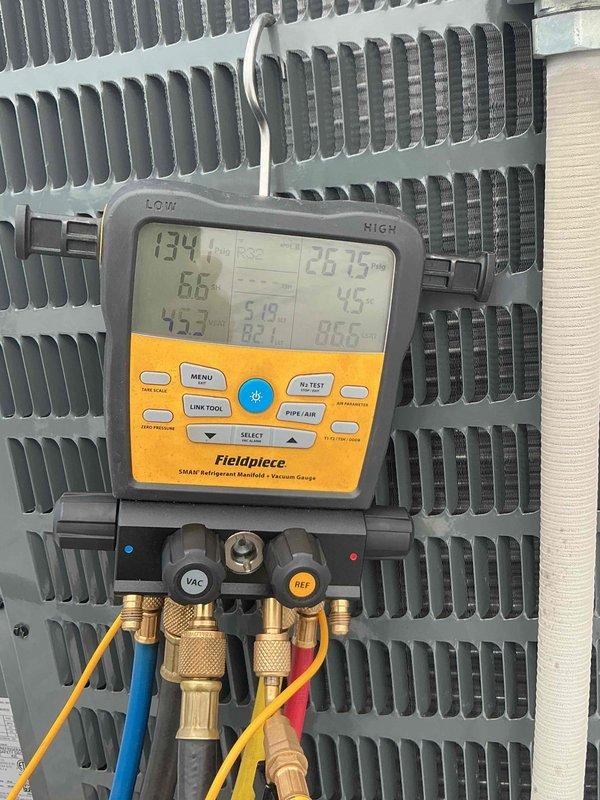 Completed installation of 3.5 ton York split system air conditioning unit with matching evaporator coil for middle office area in unit 32. Equipment was transported from office location and hoisted into position using mechanical lift assistance. Following installation, system was charged with refrigerant and comprehensive diagnostics were performed using digital manifold gauges to verify proper operating pressures, temperatures, and vacuum levels, confirming unit is functioning within manufacturer specifications.