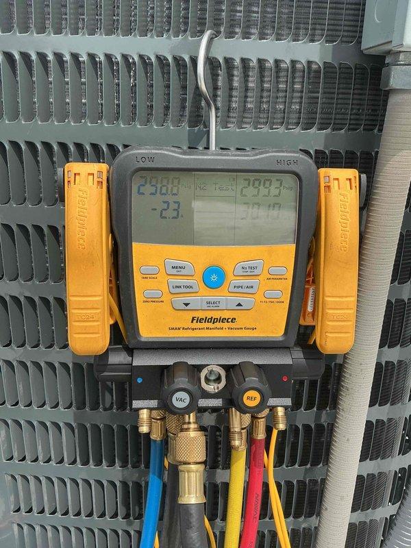 Completed installation of 3.5 ton York split system air conditioning unit with matching evaporator coil for middle office area in unit 32. Equipment was transported from office location and hoisted into position using mechanical lift assistance. Following installation, system was charged with refrigerant and comprehensive diagnostics were performed using digital manifold gauges to verify proper operating pressures, temperatures, and vacuum levels, confirming unit is functioning within manufacturer specifications.