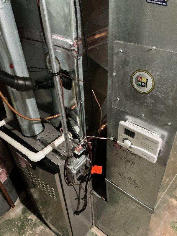 Completed install callback addressing three items: installed C-clamp to secure power humidifier electrical cord, modified return air plenum opening on back side to ensure flush magnet contact, and applied additional foil tape to seal significant air leakage at bottom left section of evaporator coil near drain connection.