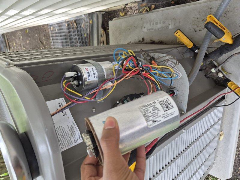 Responded to no cooling complaint on residential air conditioning system. Upon arrival, verified thermostat settings and confirmed unit was not producing cold air. Performed diagnostic evaluation of outdoor condensing unit with access panel removed. Tested capacitor using digital multimeter to measure microfarad values and voltage readings. Measurements indicated failed dual run capacitor preventing compressor and condenser fan motor from operating properly. Removed defective capacitor from mounting bracket and installed replacement capacitor with correct specifications. Verified all electrical connections were secure and properly terminated. Cycled system through complete operational test to confirm compressor startup, proper amperage draw, and adequate airflow from condenser fan motor. Unit returned to normal cooling operation with no further issues observed.